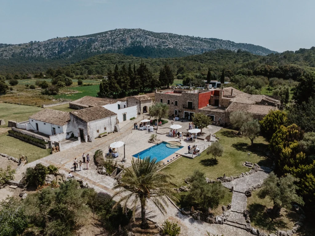 Aerial view of a Mallorca finca wedding venue with pool, olive trees and mountain backdrop