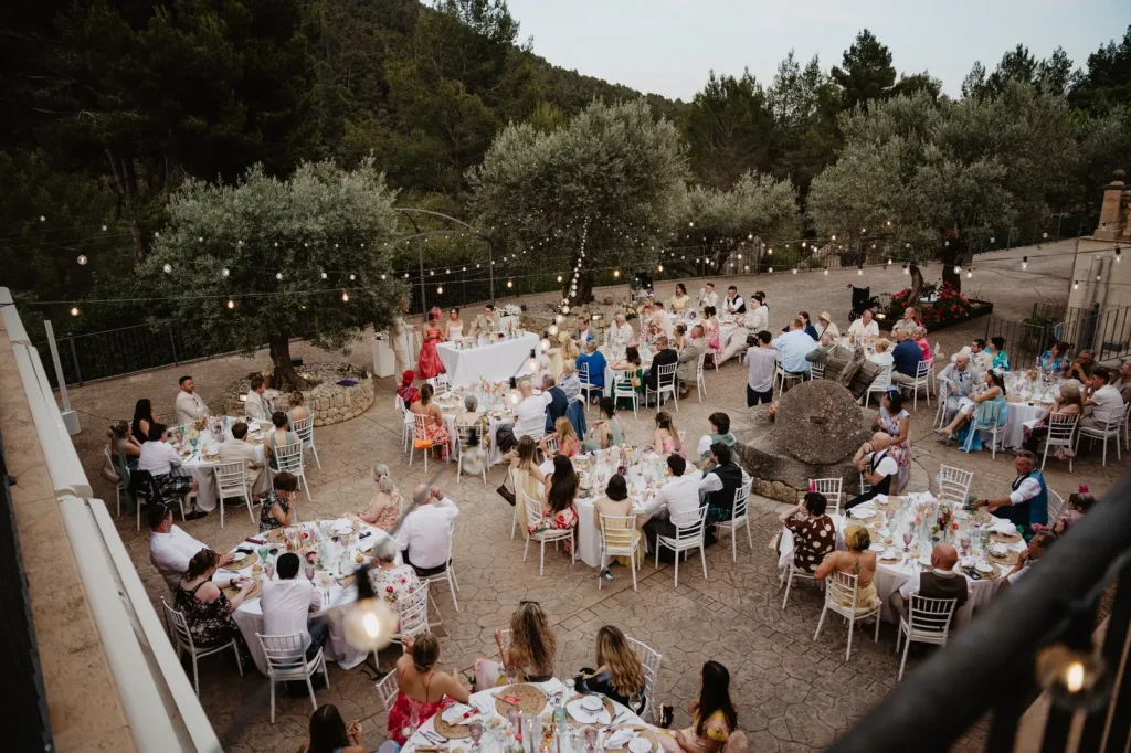 Outdoor wedding dinner at a Mallorca finca surrounded by olive trees