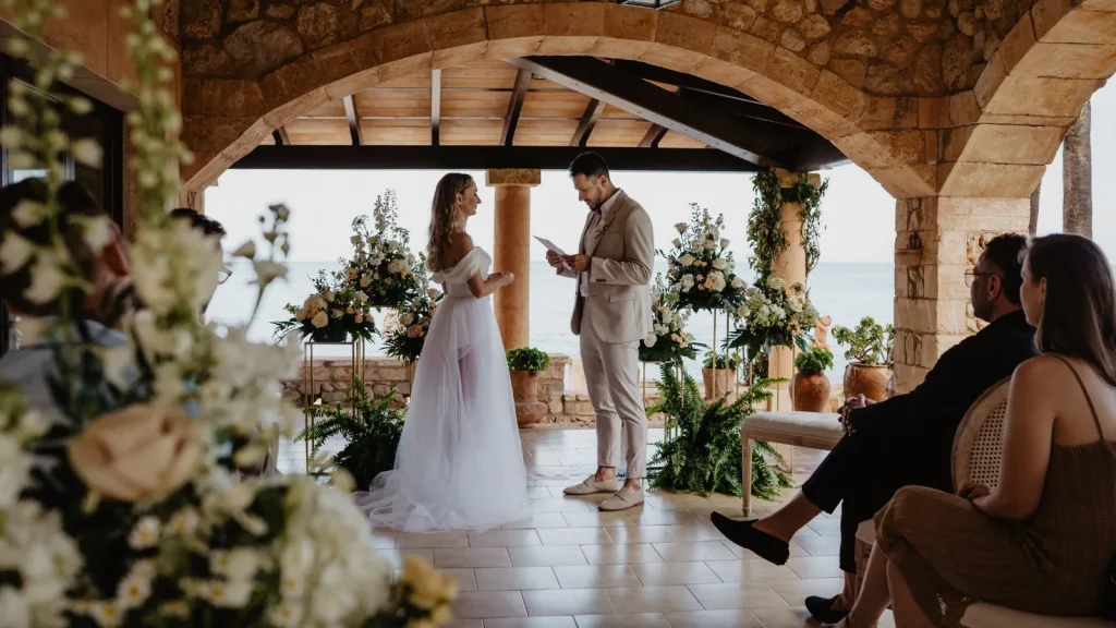 Covered ceremony under stone arches prepared as a Mallorca wedding weather backup plan