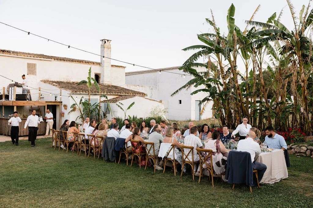 Wedding guests enjoying an outdoor dinner at a traditional Mallorca finca